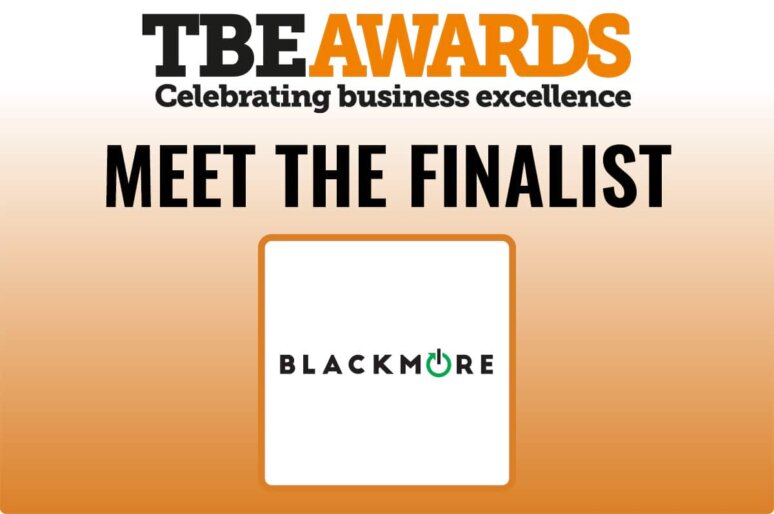 Graphic for the TBE Awards with the headline “TBE Awards – Celebrating business excellence” in black and orange text. Below, bold black text reads “MEET THE FINALIST.” Underneath is a white square with an orange border containing the Blackmore logo, which features the word “BLACKMORE” in black uppercase letters with the letter “O” stylised as a green power button symbol. The background fades from white at the top to orange at the bottom.