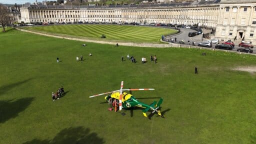 Aerial photo of the Wiltshire and Bath Air Ambulance Charity helicopter at the Royal Cresent in Bath